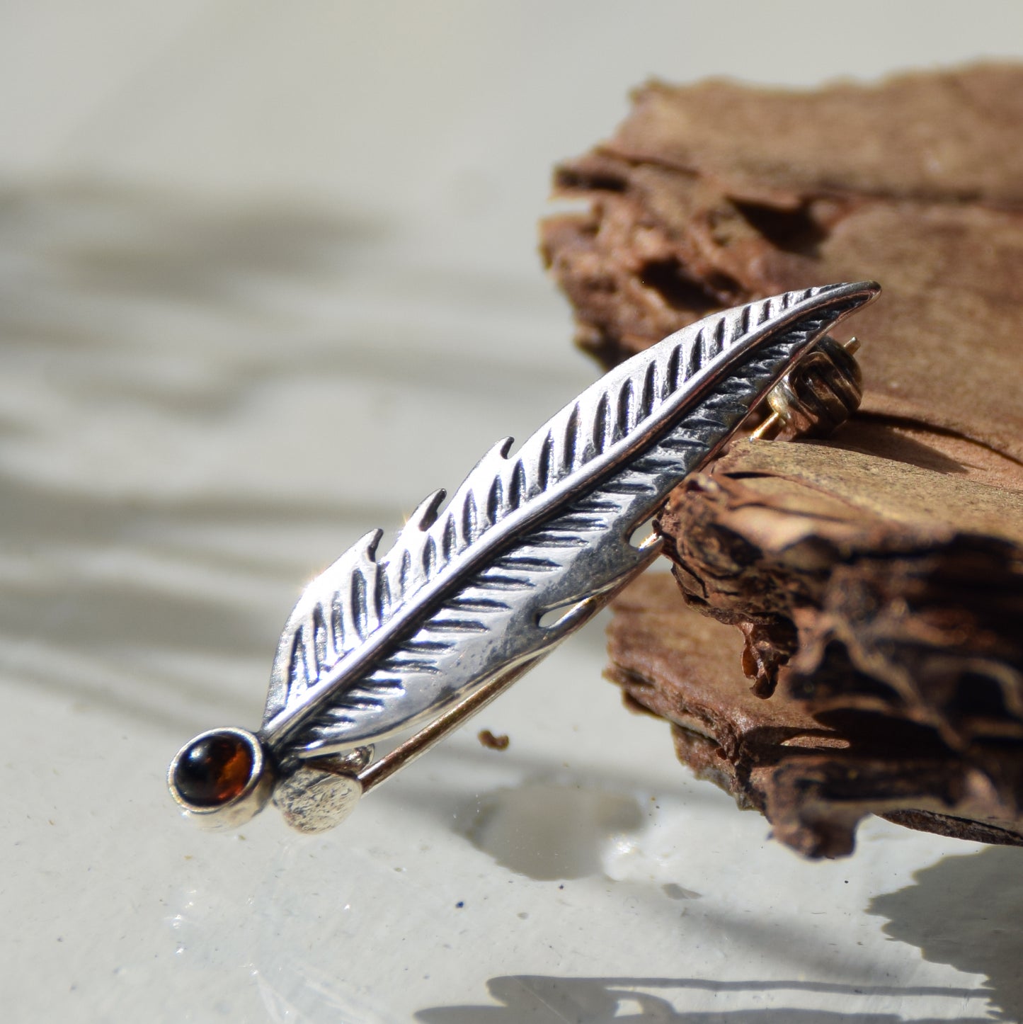 Delicate feather brooch made with natural cognac-colored amber and 925 silver, MJ Baltica, BBR050