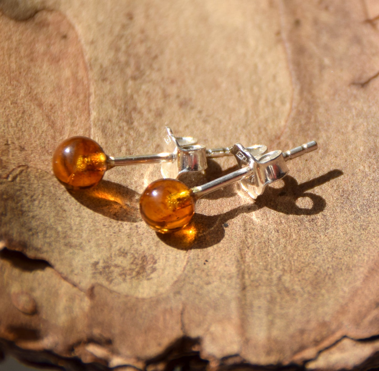 Essential earrings created with natural cognac-colored Amber spheres and 925 Silver, MJ Baltica, BK234