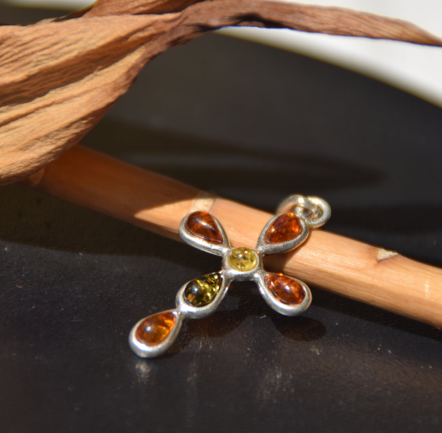 Delicate cross-shaped pendant made of natural amber in various shades and 925 sterling silver, MJ Baltica, BW257