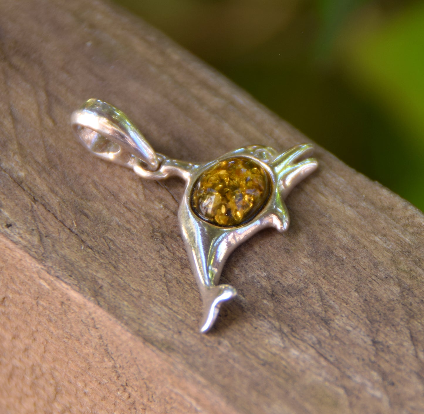 Delicate pendant with a joyful dolphin in natural green amber and 925 silver, MJ Baltica, BW320