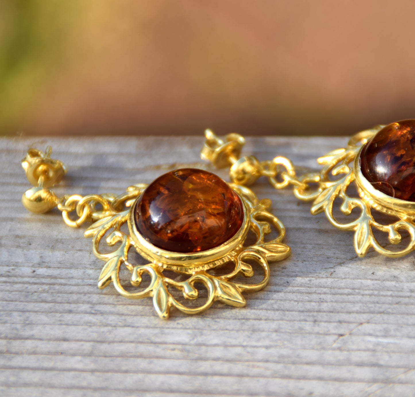 Elegant round floral earrings crafted from natural cognac amber and 18k gold-plated 925 sterling silver, MJ Baltica, BZK180