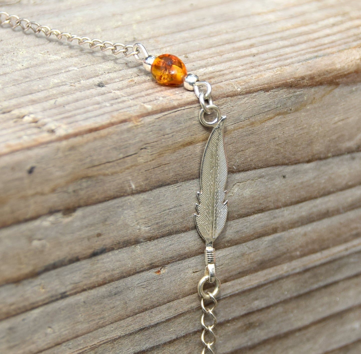 Delicato bracciale con luminosa piuma in Ambra naturale color cognac e Argento 925, MJ Baltica, BB005
