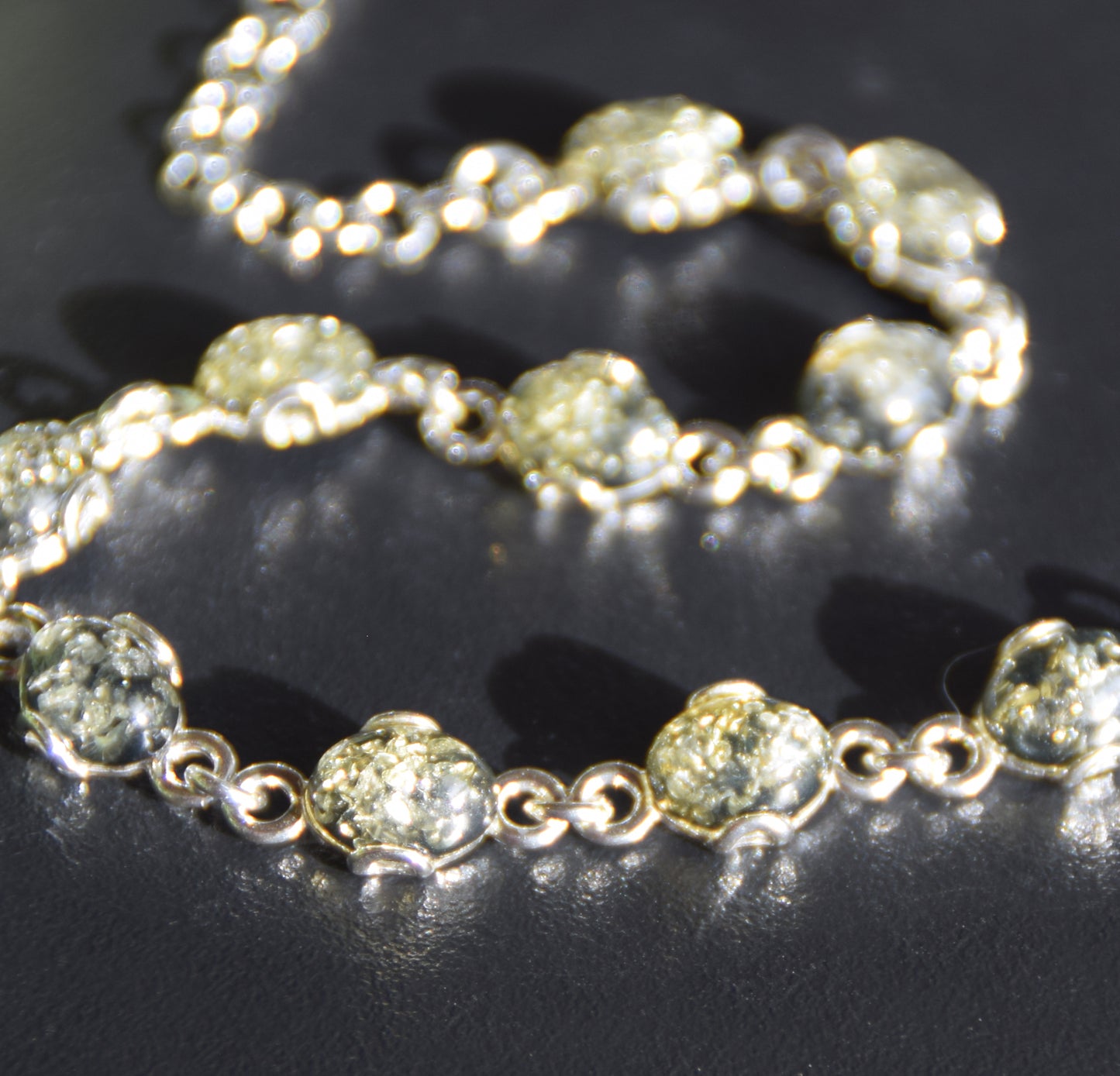Adjustable chain bracelet in an essential style crafted from natural green amber and 925 sterling silver, MJ Baltica, BB105