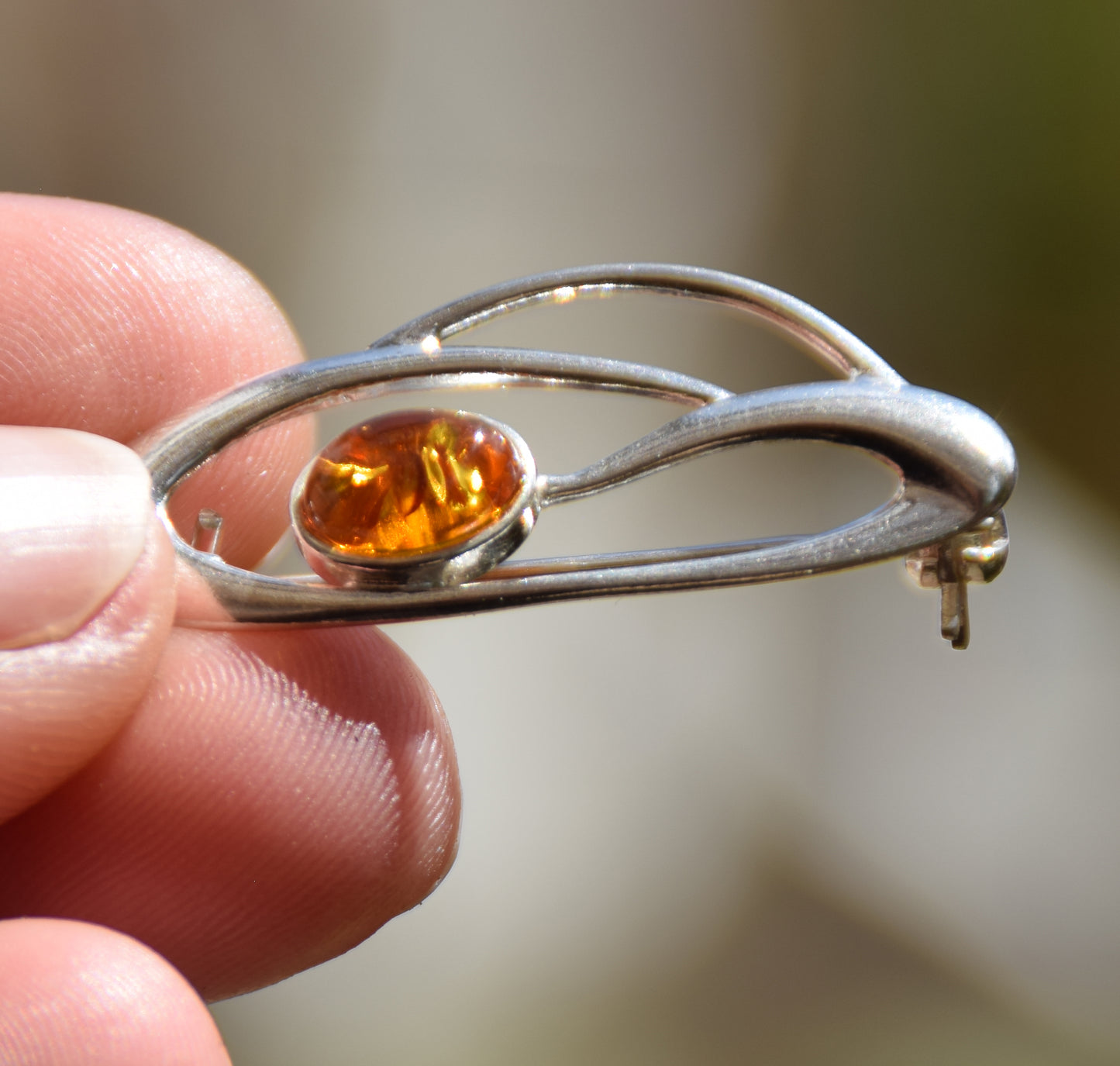 Delicate brooch created with natural cognac-colored amber and 925 Silver, MJ Baltica, BBR002