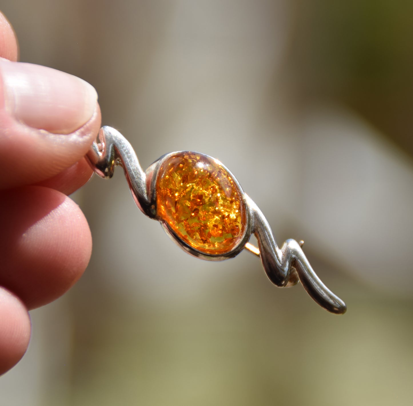Elegant abstract style brooch crafted with cognac-colored natural Amber and 925 Sterling Silver, MJ Baltica, BBR003