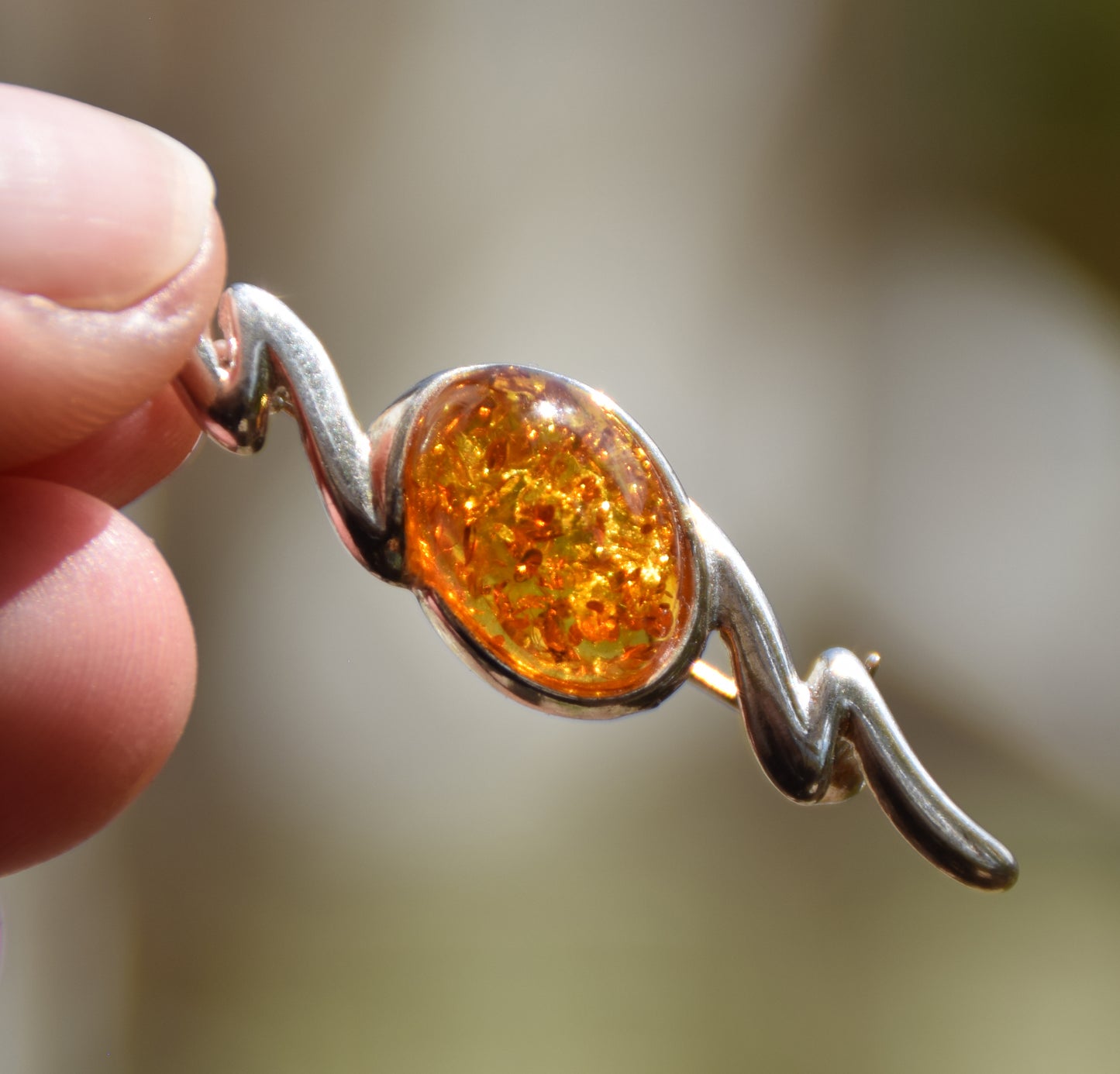 Elegant abstract style brooch crafted with cognac-colored natural Amber and 925 Sterling Silver, MJ Baltica, BBR003