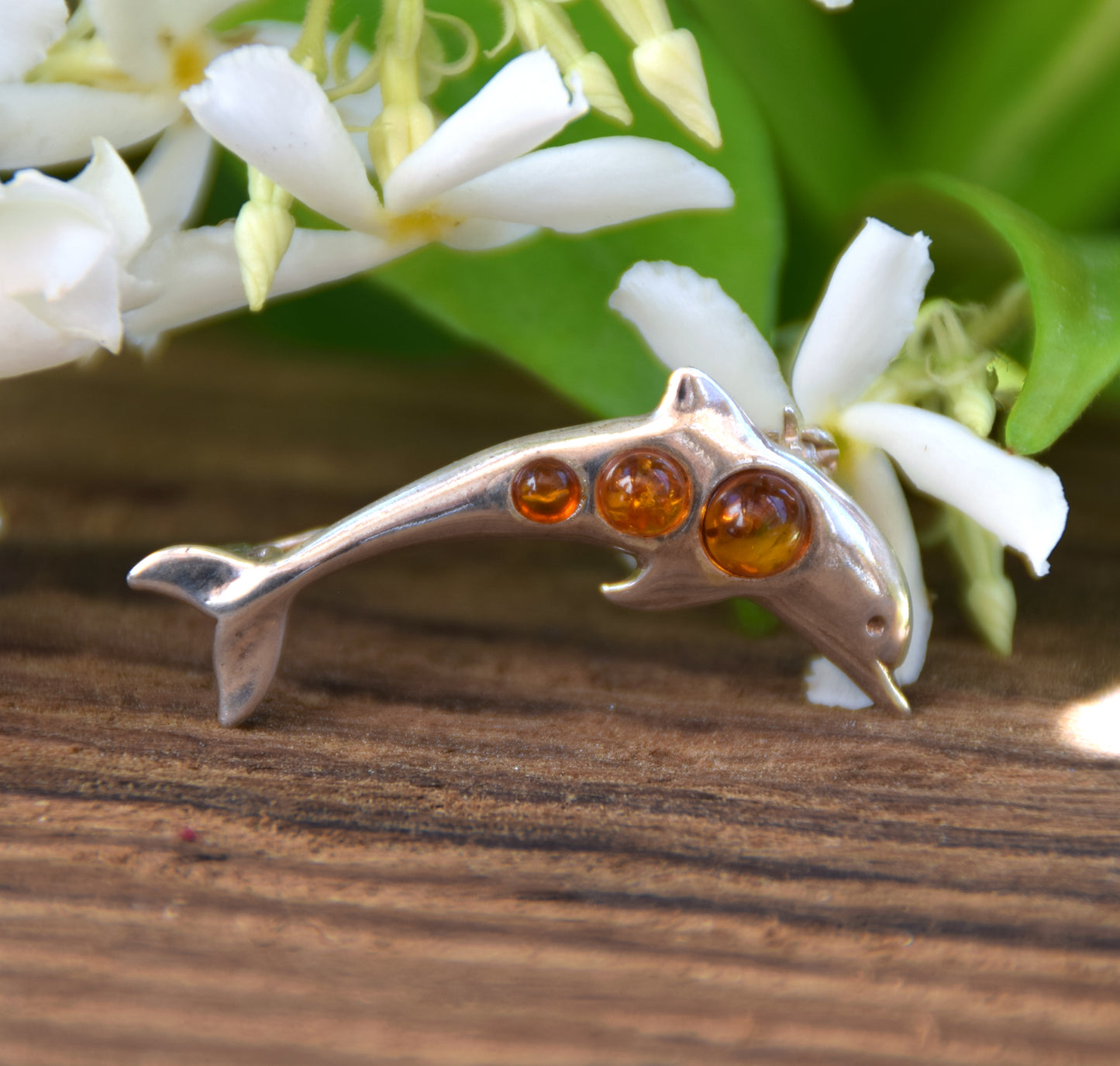 Delicate dolphin-shaped brooch crafted from natural cognac amber and 925 Sterling Silver, MJ Baltica, BBR013
