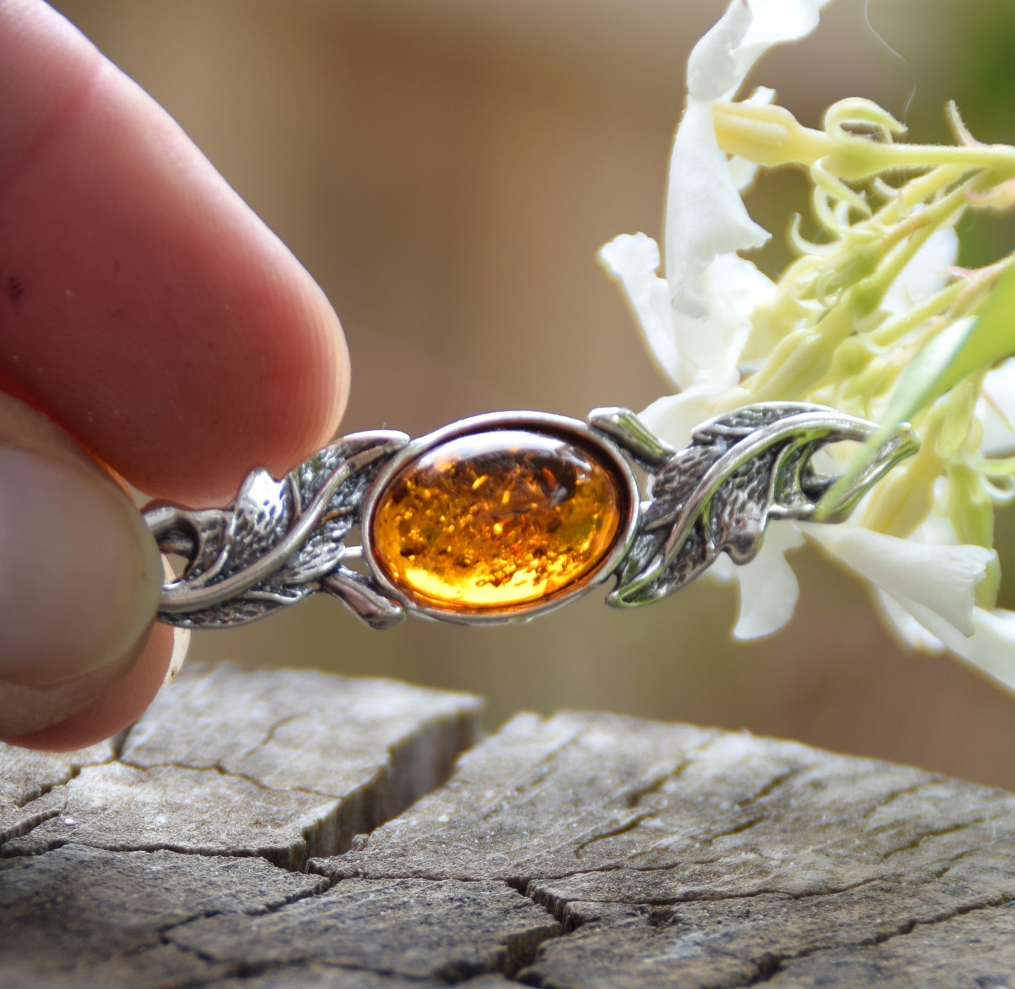 Vintage-style floral design brooch crafted with natural cognac amber and 925 silver, MJ Baltica, BBR017
