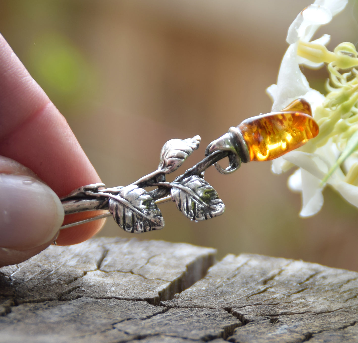 Elegant rose-shaped brooch crafted from natural cognac amber and 925 sterling silver, MJ Baltica, BBR030