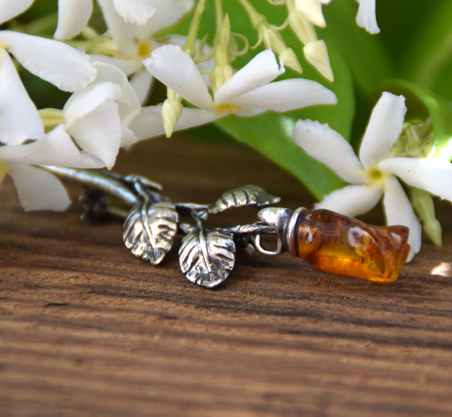 Elegant rose-shaped brooch crafted from natural cognac amber and 925 sterling silver, MJ Baltica, BBR030