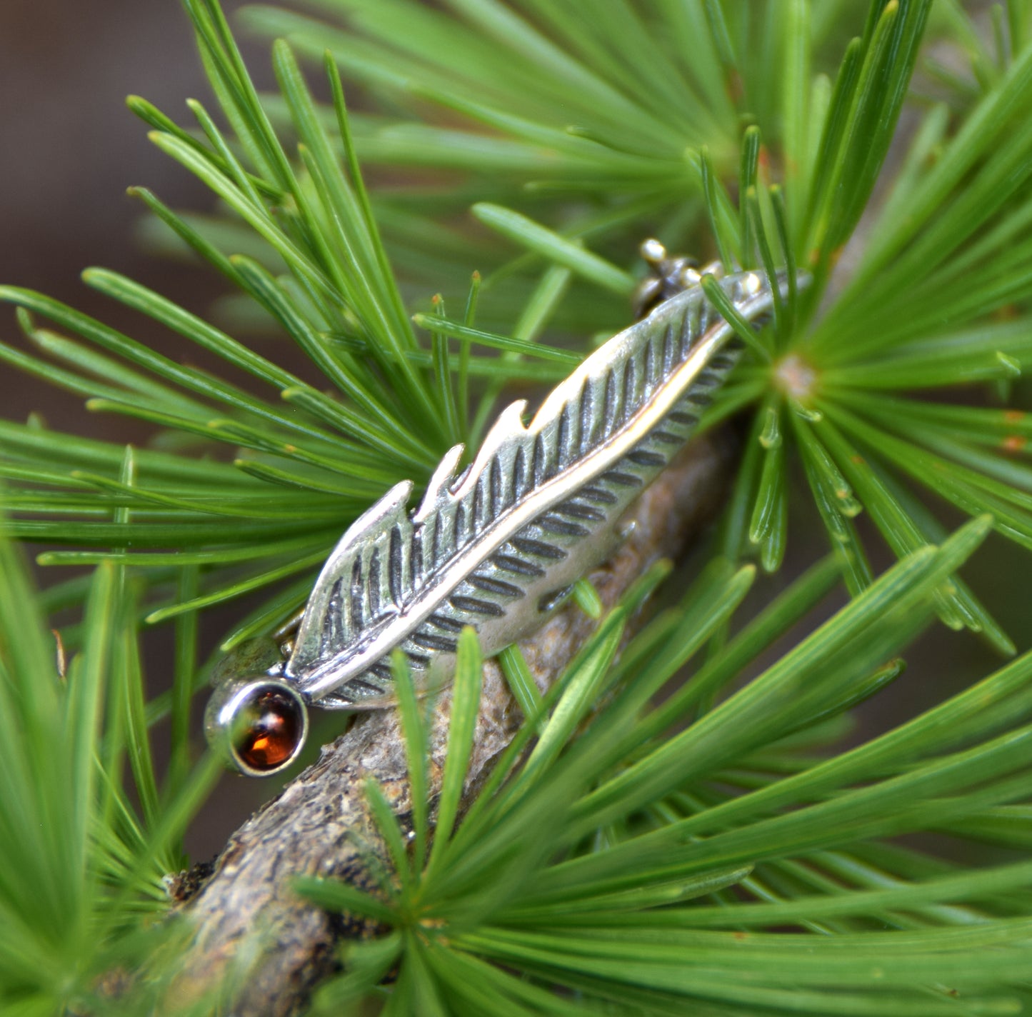 Delicate feather brooch made with natural cognac-colored amber and 925 silver, MJ Baltica, BBR050