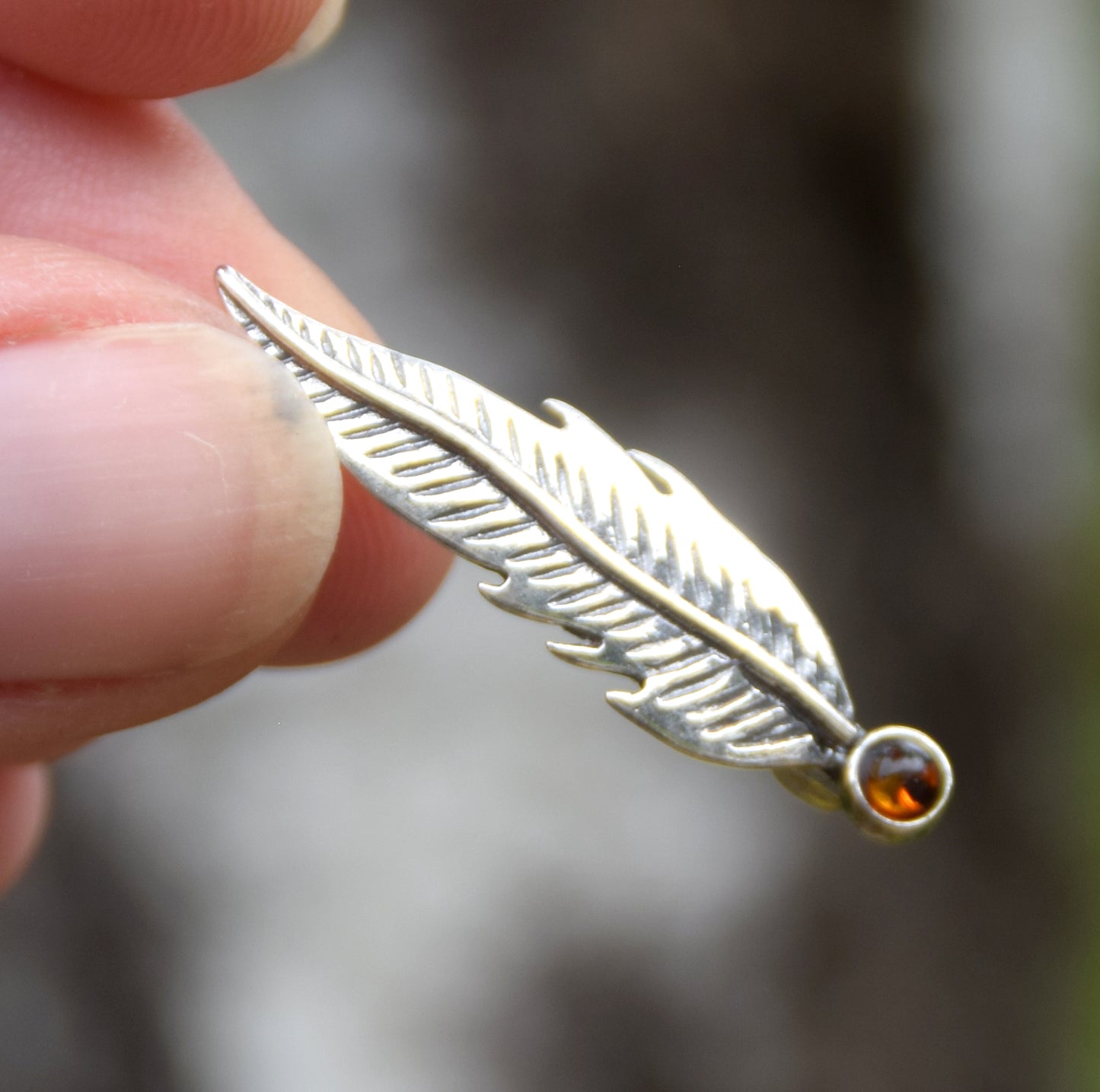 Delicate feather brooch made with natural cognac-colored amber and 925 silver, MJ Baltica, BBR050