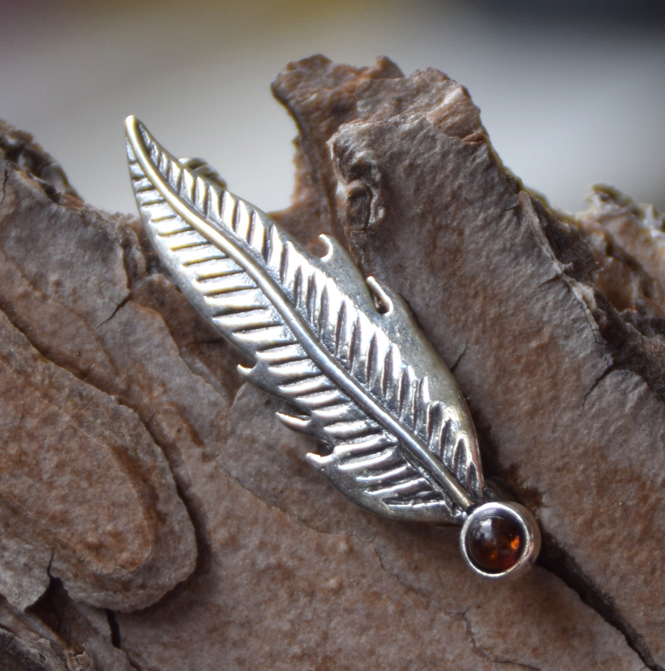 Delicate feather brooch made with natural cognac-colored amber and 925 silver, MJ Baltica, BBR050