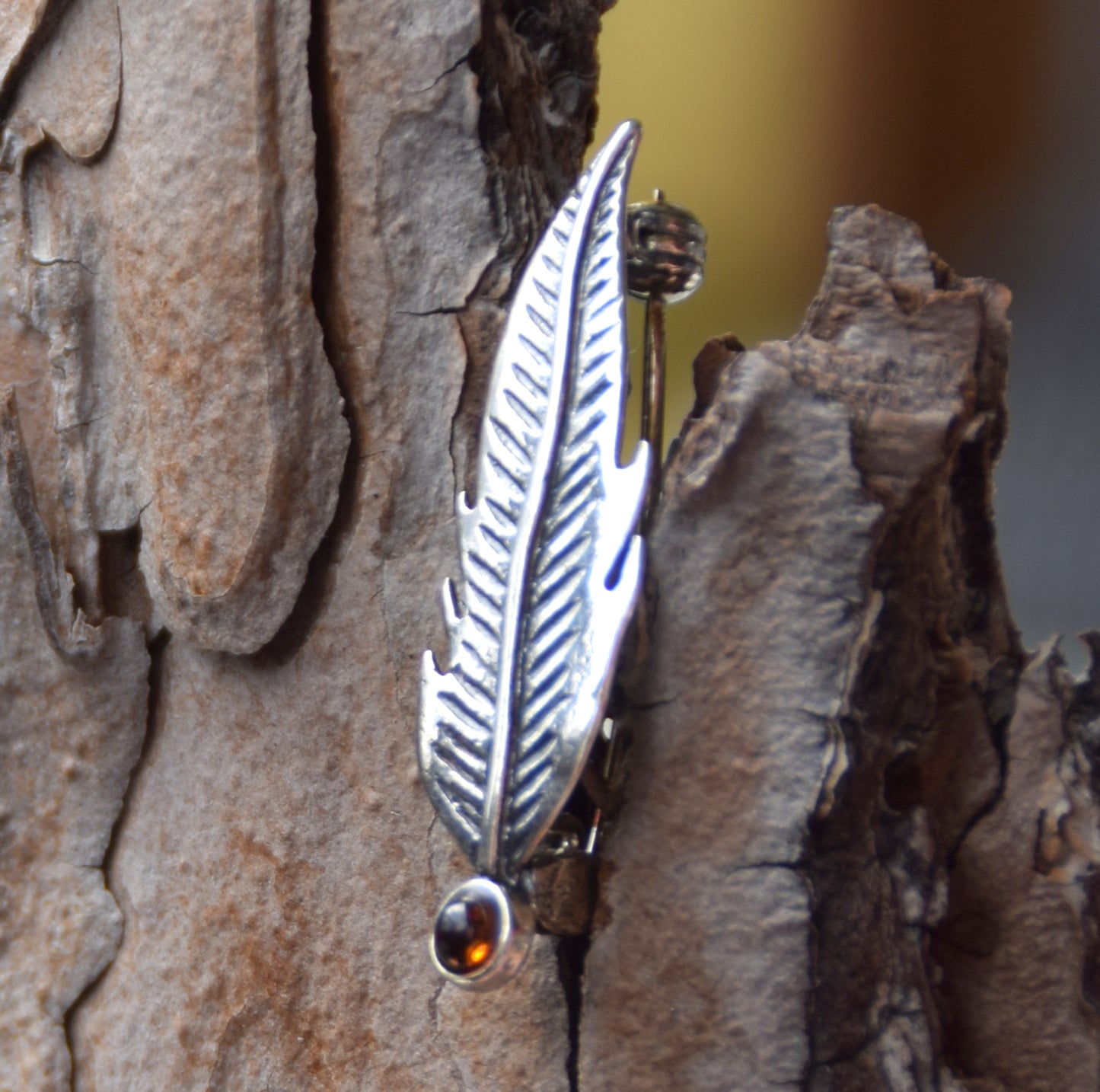 Delicate feather brooch made with natural cognac-colored amber and 925 silver, MJ Baltica, BBR050