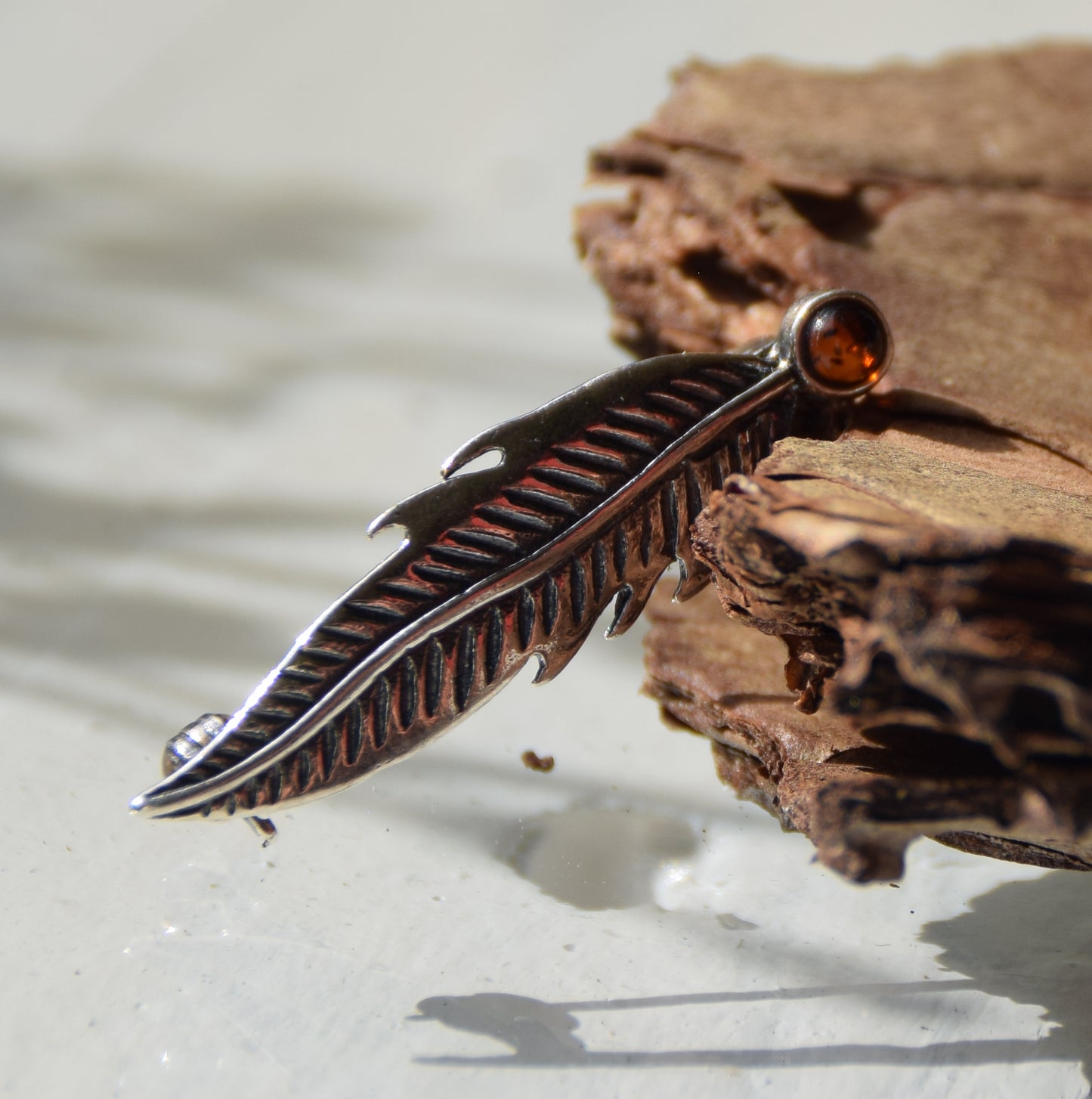 Delicate feather brooch made with natural cognac-colored amber and 925 silver, MJ Baltica, BBR050