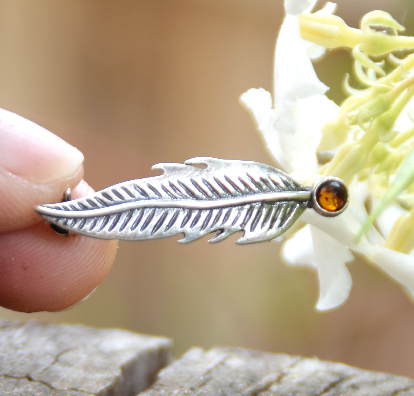 Delicate feather brooch made with natural cognac-colored amber and 925 silver, MJ Baltica, BBR050