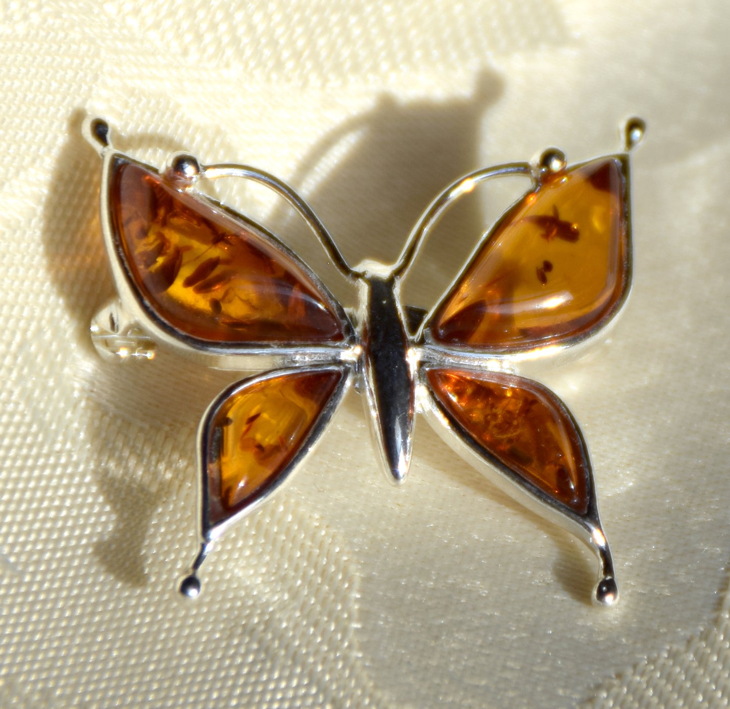 Bright butterfly brooch made with natural cognac Amber and 925 Silver, MJ Baltica, BBR056