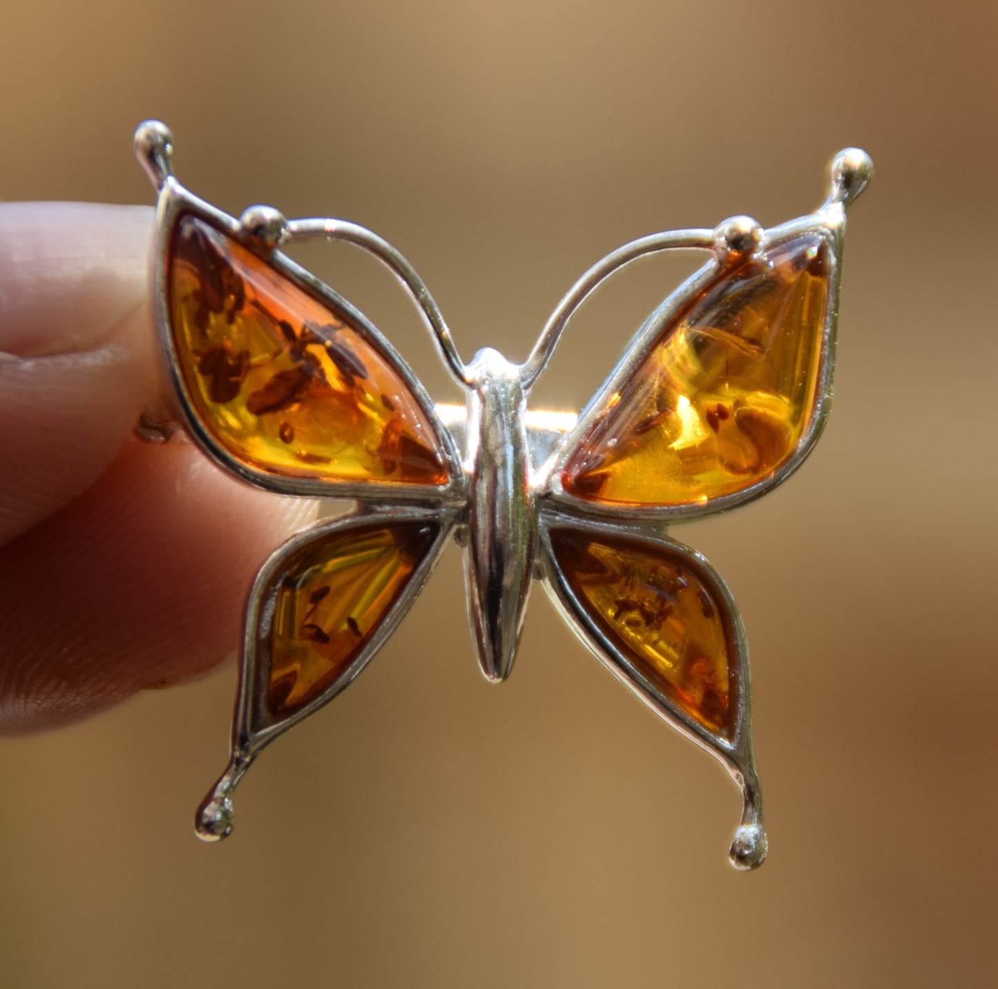 Bright butterfly brooch made with natural cognac Amber and 925 Silver, MJ Baltica, BBR056