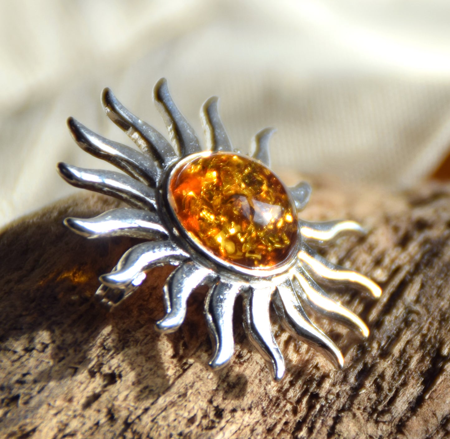 Bright sun-shaped brooch made with natural cognac-colored Amber and 925 Silver, MJ Baltica, BBR057