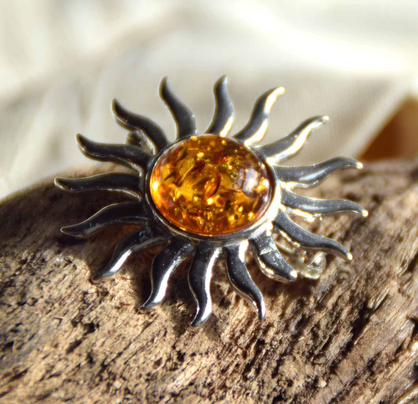 Bright sun-shaped brooch made with natural cognac-colored Amber and 925 Silver, MJ Baltica, BBR057