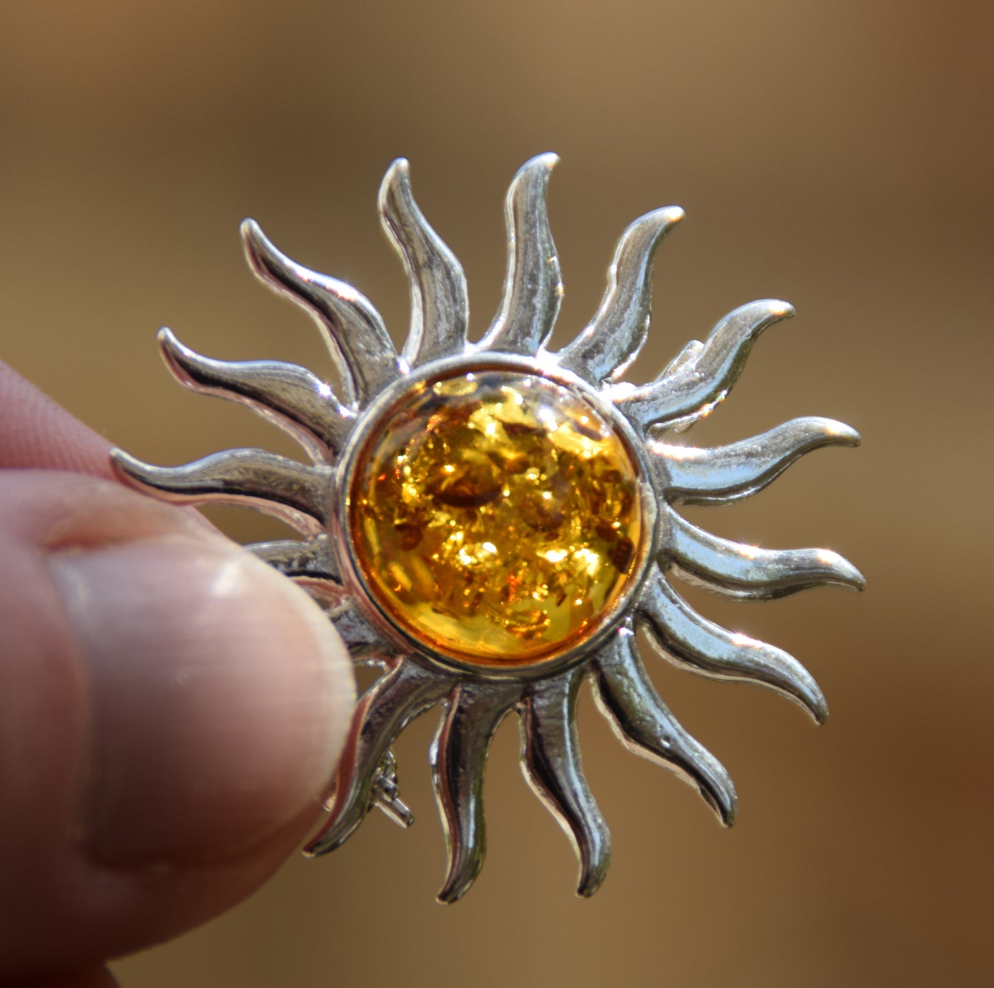 Bright sun-shaped brooch made with natural cognac-colored Amber and 925 Silver, MJ Baltica, BBR057