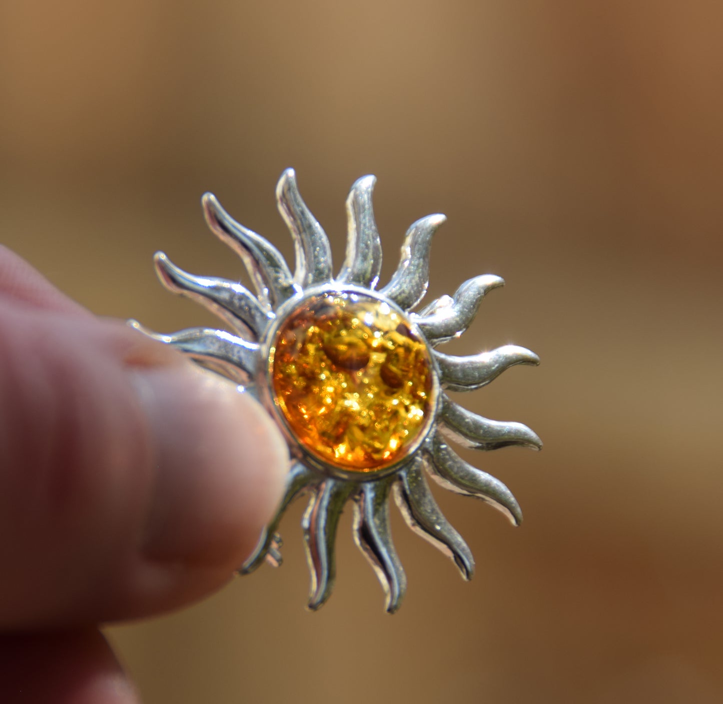 Bright sun-shaped brooch made with natural cognac-colored Amber and 925 Silver, MJ Baltica, BBR057