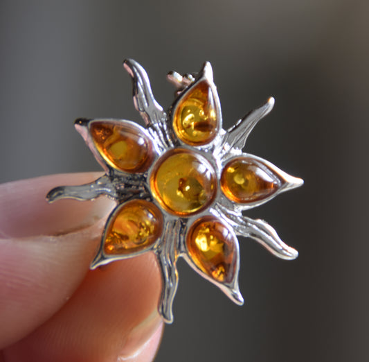 Sun-shaped brooch crafted with a mosaic of natural cognac Amber gemstones and 925 Silver, MJ Baltica, BBR059