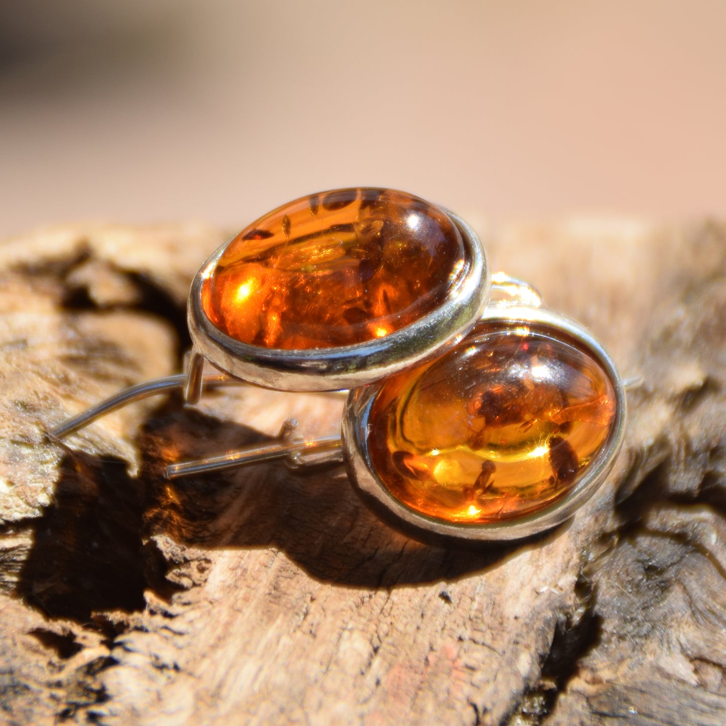 Bright earrings with a leverback closure, made with natural cognac-colored oval Amber and 925 Silver, MJ Baltica, BK047
