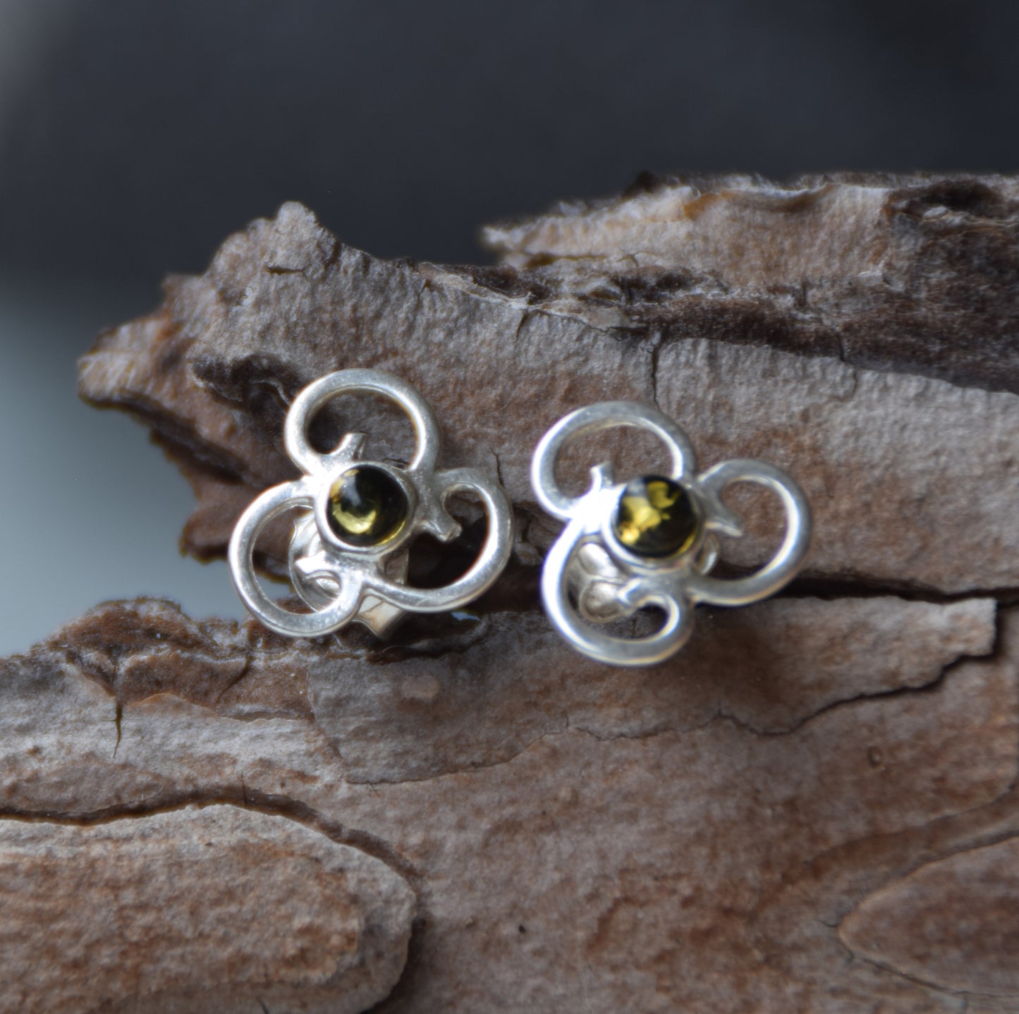 Triskel-shaped earrings crafted with natural green amber and 925 silver, MJ Baltica, BK232