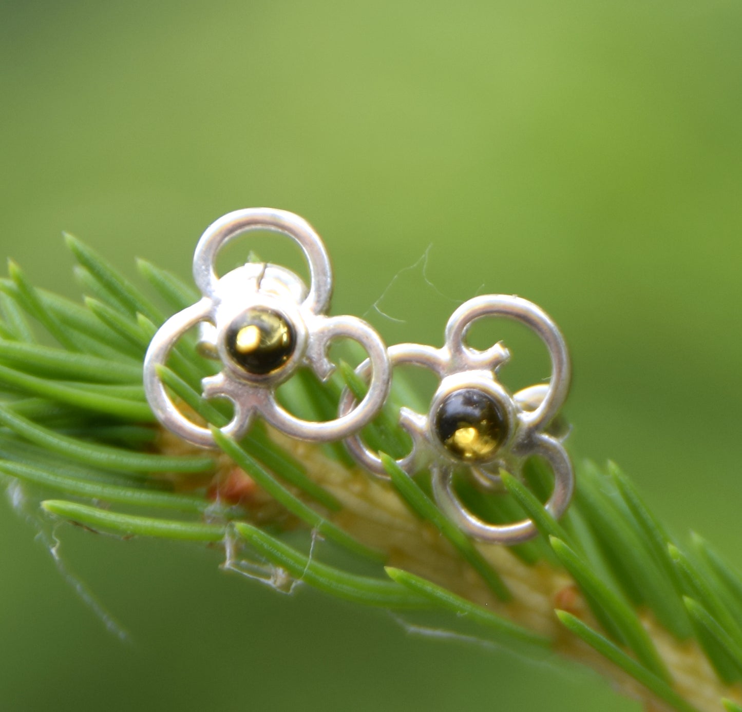 Triskel-shaped earrings crafted with natural green amber and 925 silver, MJ Baltica, BK232