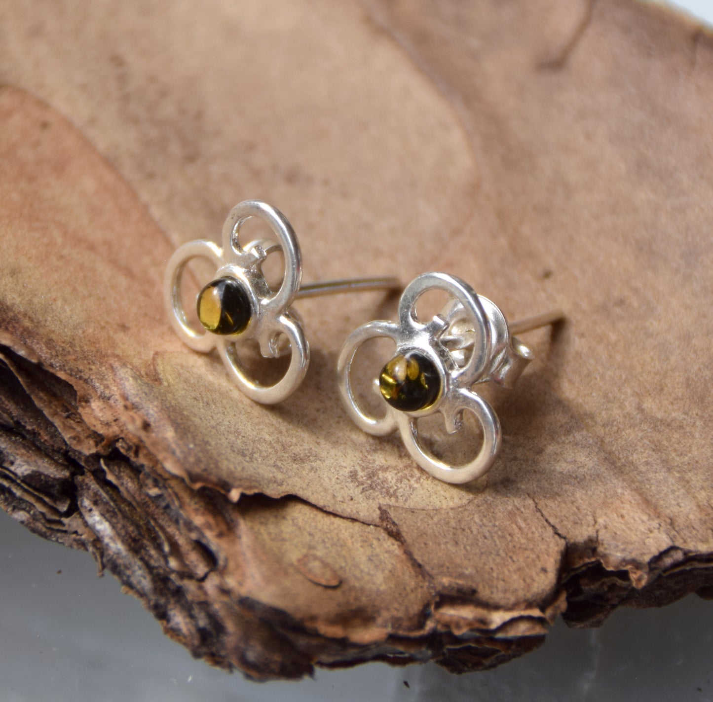 Triskel-shaped earrings crafted with natural green amber and 925 silver, MJ Baltica, BK232