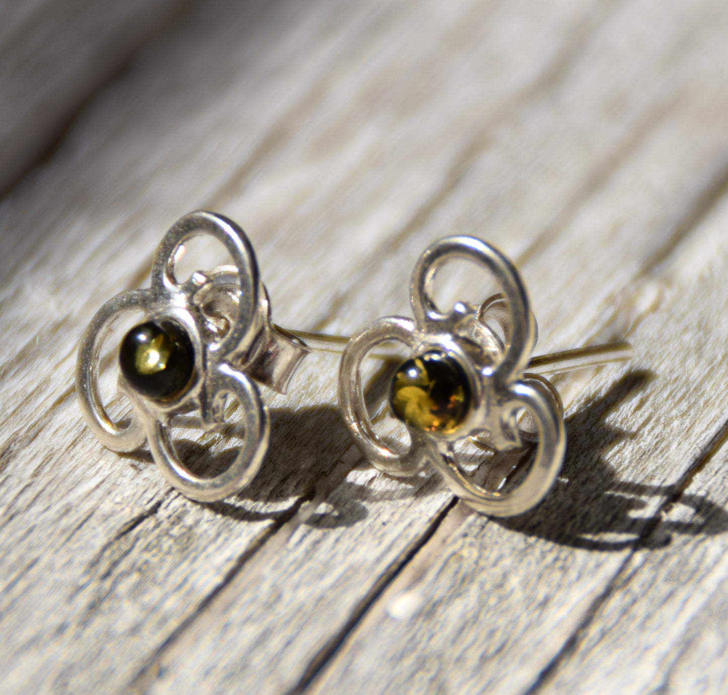 Triskel-shaped earrings crafted with natural green amber and 925 silver, MJ Baltica, BK232