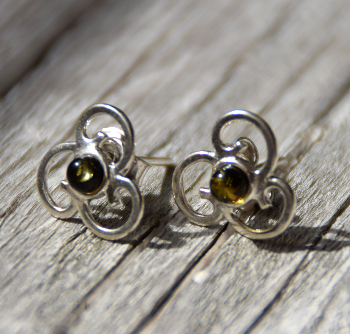 Triskel-shaped earrings crafted with natural green amber and 925 silver, MJ Baltica, BK232