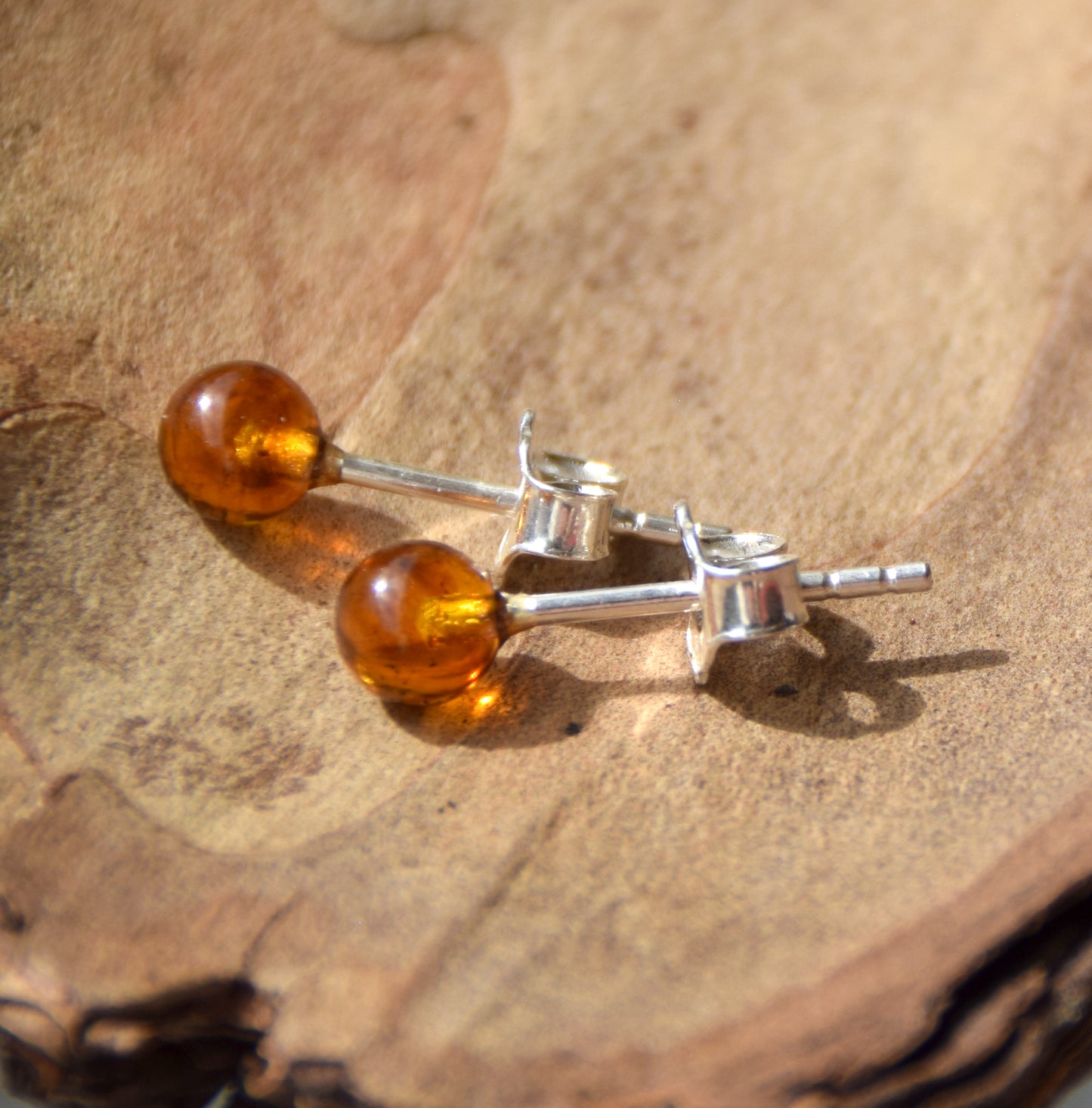 Essential earrings created with natural cognac-colored Amber spheres and 925 Silver, MJ Baltica, BK234