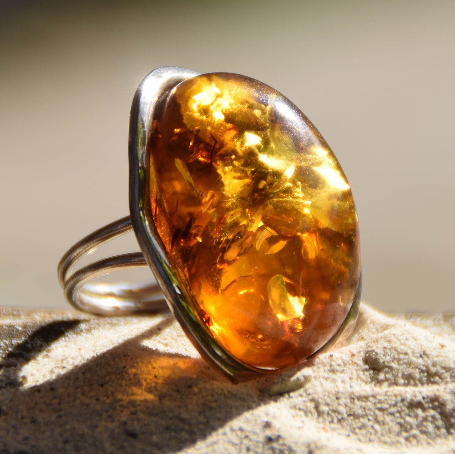 Large adjustable ring with cognac-colored oval natural amber gemstone and 925 Sterling Silver, MJ Baltica, BP108