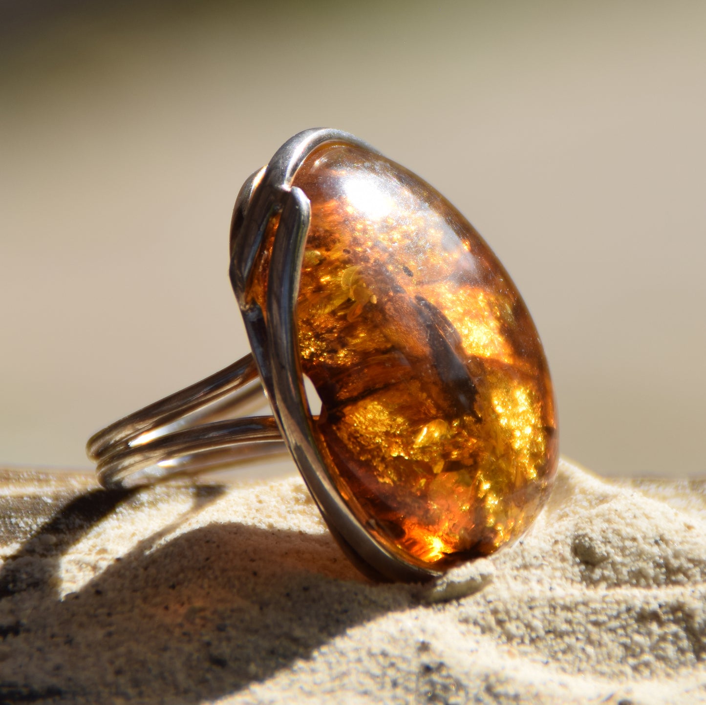 Large ring crafted with Cognac-colored Natural Amber with various inclusions and 925 Silver, MJ Baltica, BP115