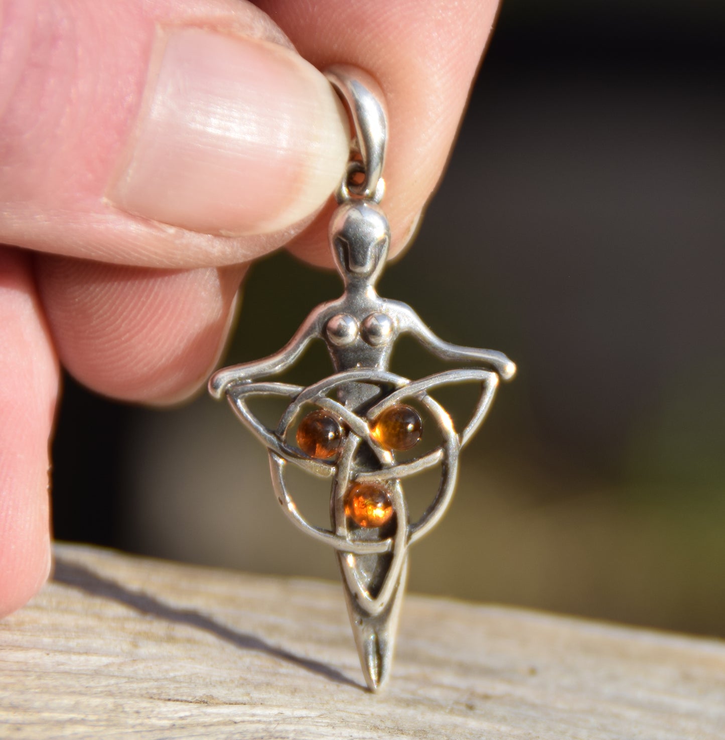 Celtic fairy pendant holding a triskele adorned with natural cognac amber, MJ Baltica, BW050