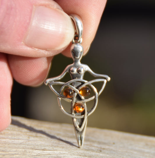Celtic fairy pendant holding a triskele adorned with natural cognac amber, MJ Baltica, BW050