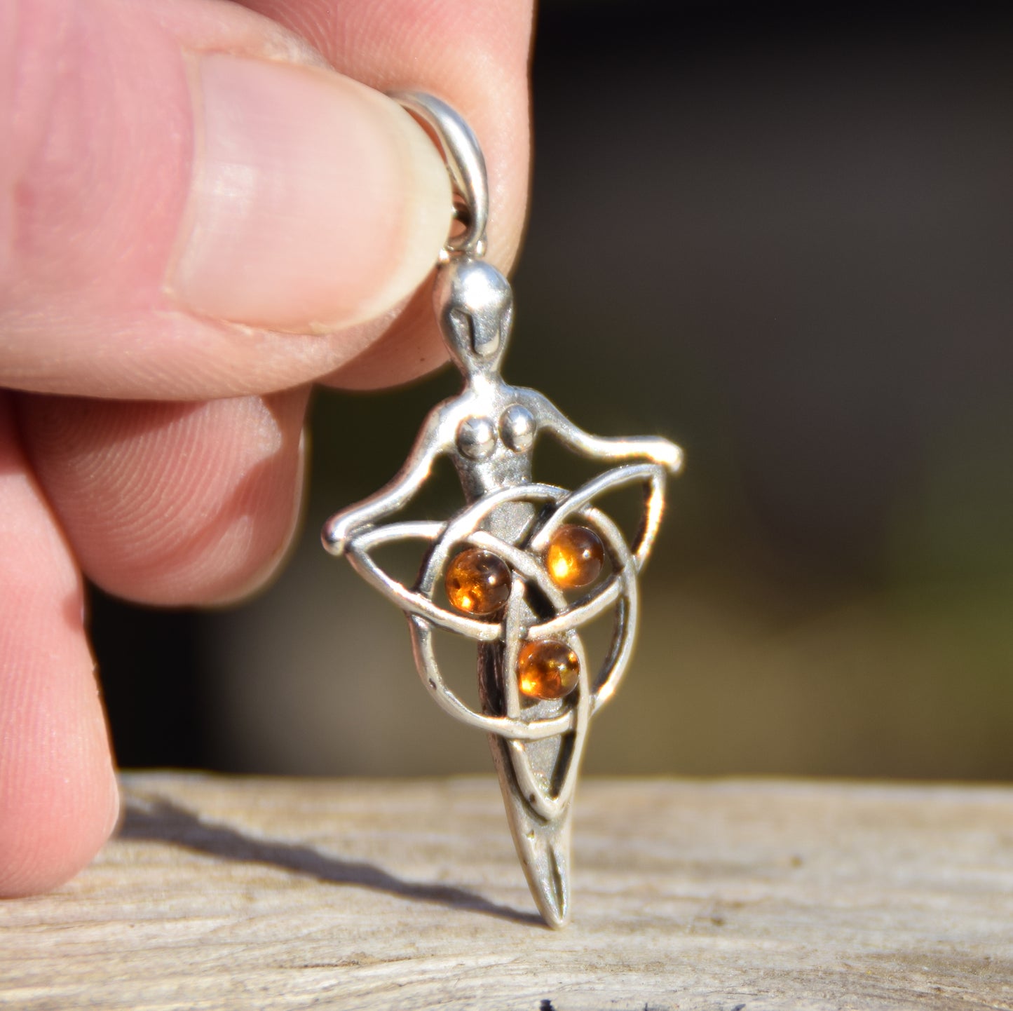 Celtic fairy pendant holding a triskele adorned with natural cognac amber, MJ Baltica, BW050