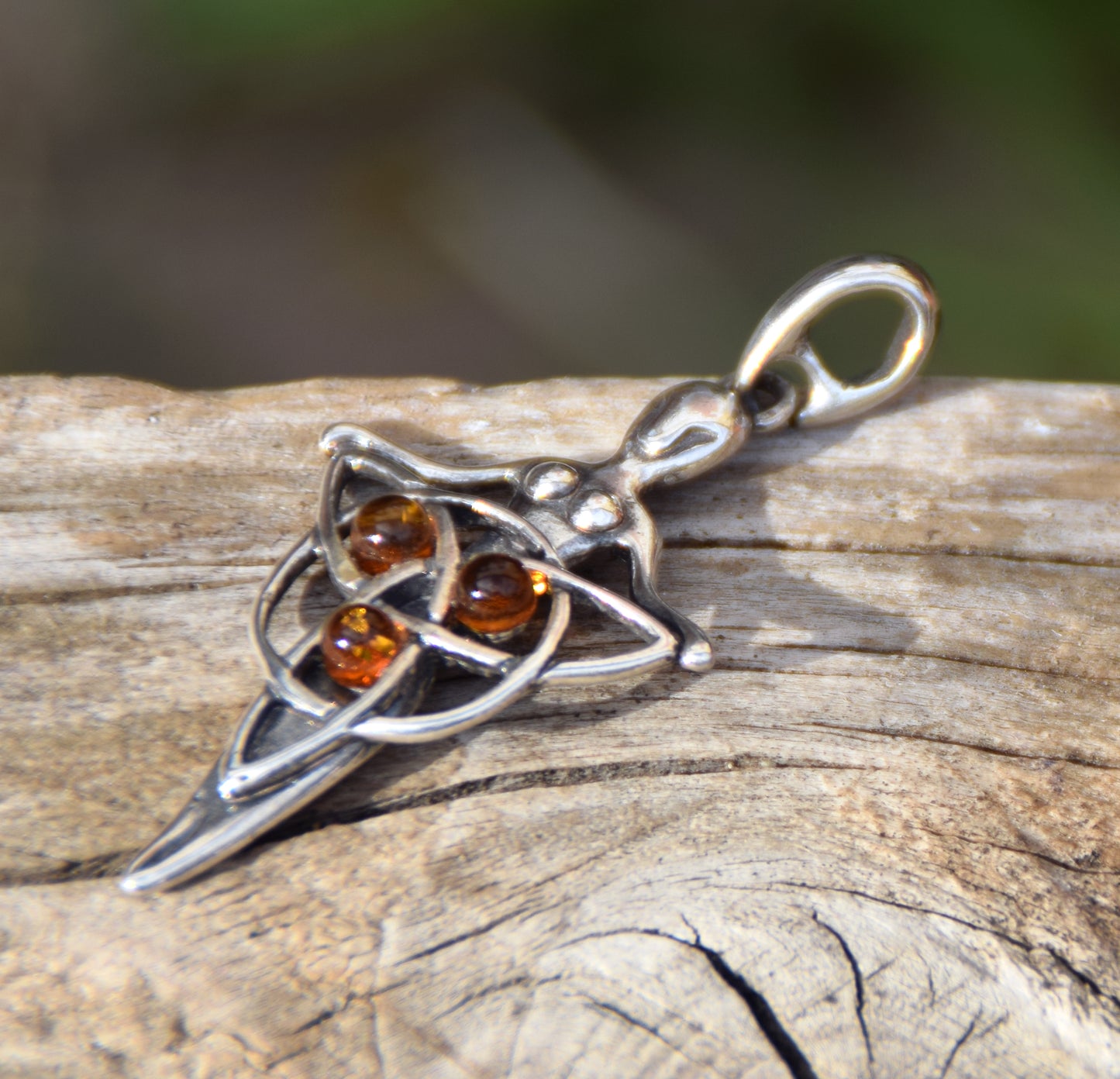 Celtic fairy pendant holding a triskele adorned with natural cognac amber, MJ Baltica, BW050