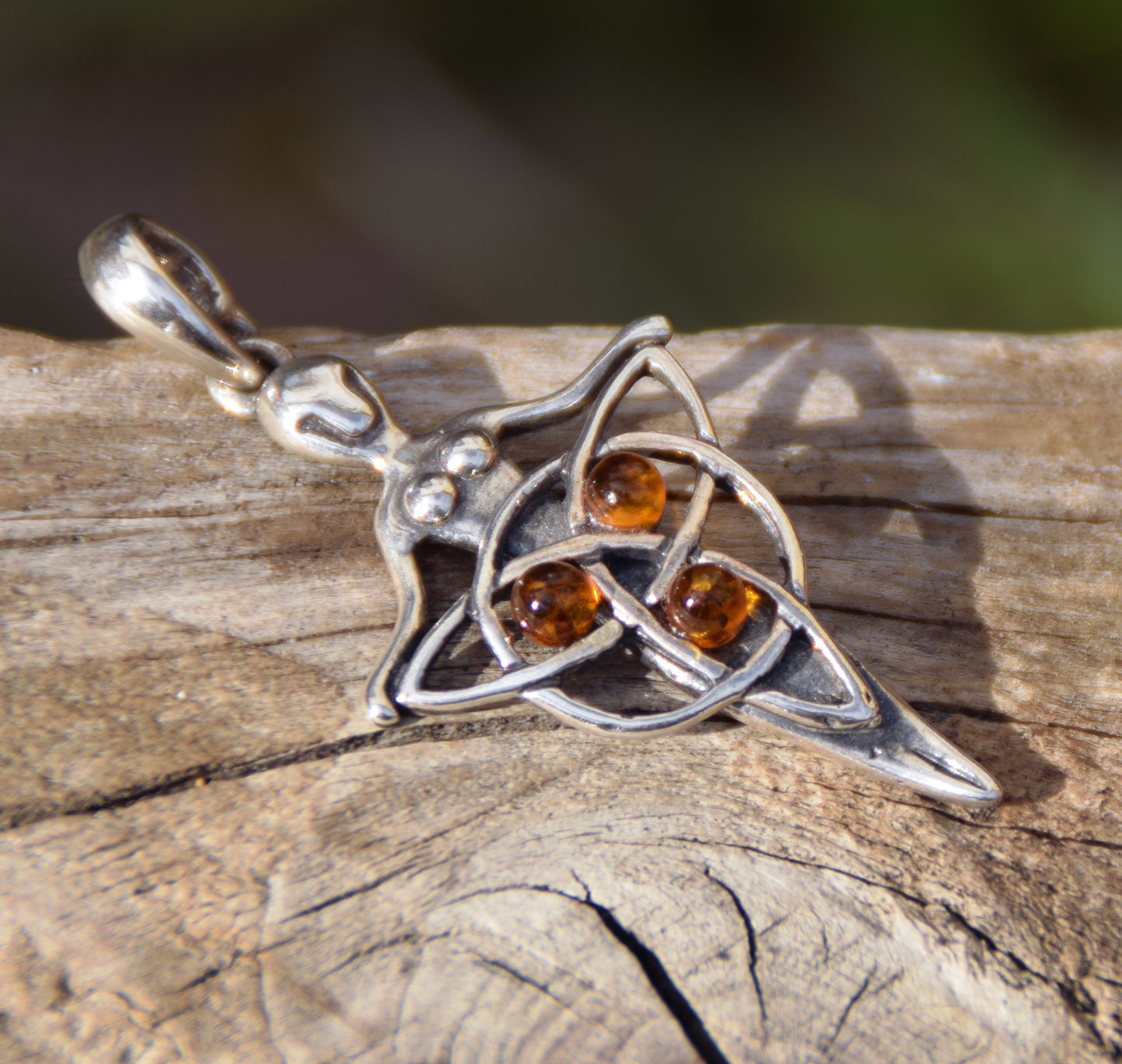 Celtic fairy pendant holding a triskele adorned with natural cognac amber, MJ Baltica, BW050