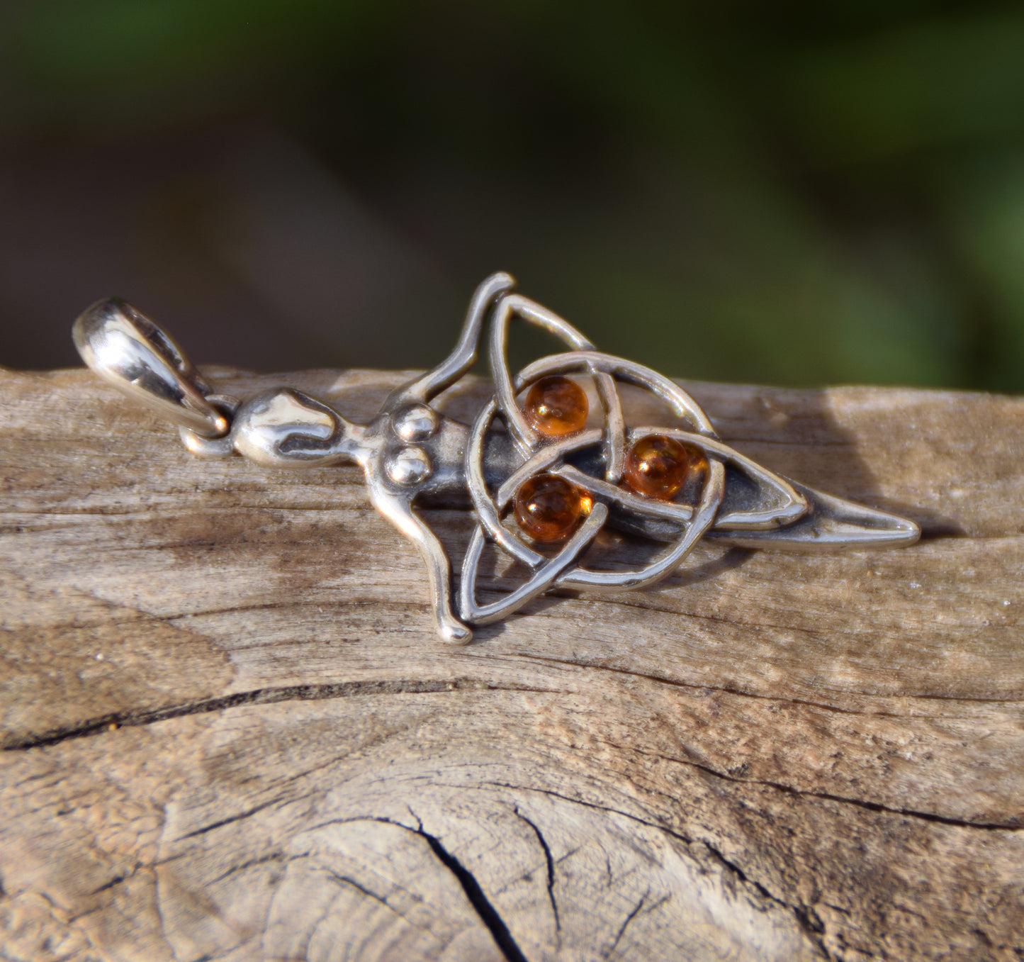 Celtic fairy pendant holding a triskele adorned with natural cognac amber, MJ Baltica, BW050