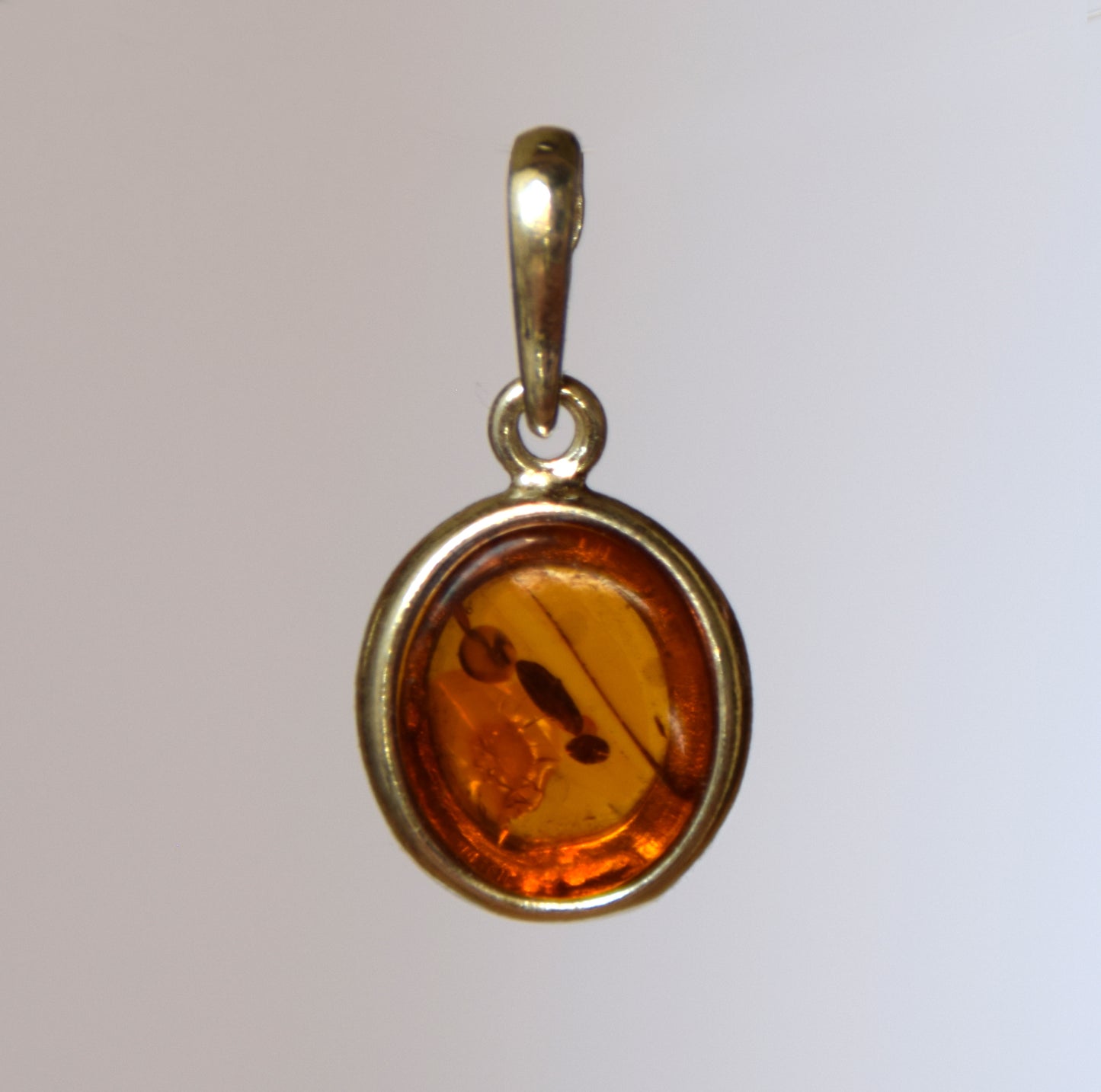 Delicate pendant created with natural cognac-colored Amber and 925 Silver, MJ Baltica, BW141