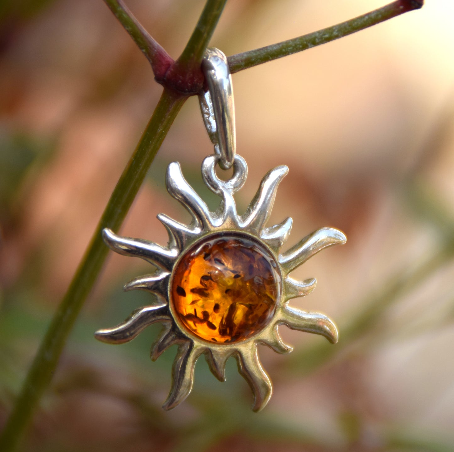 Bright sun-shaped pendant in natural cognac amber and 925 sterling silver, MJ Baltica, BW167