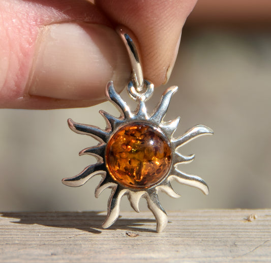 Bright sun-shaped pendant in natural cognac amber and 925 sterling silver, MJ Baltica, BW167