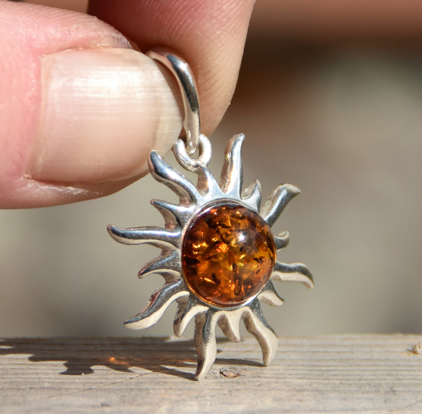 Bright sun-shaped pendant in natural cognac amber and 925 sterling silver, MJ Baltica, BW167