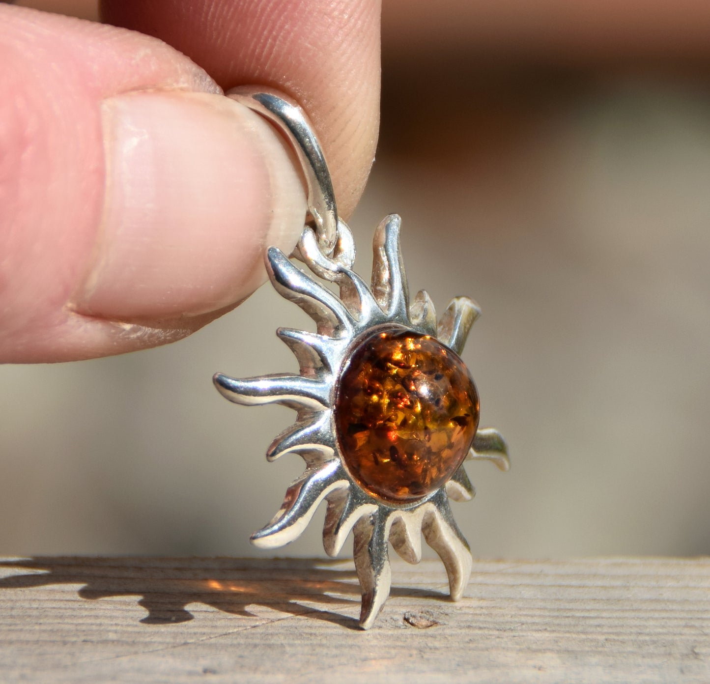 Bright sun-shaped pendant in natural cognac amber and 925 sterling silver, MJ Baltica, BW167