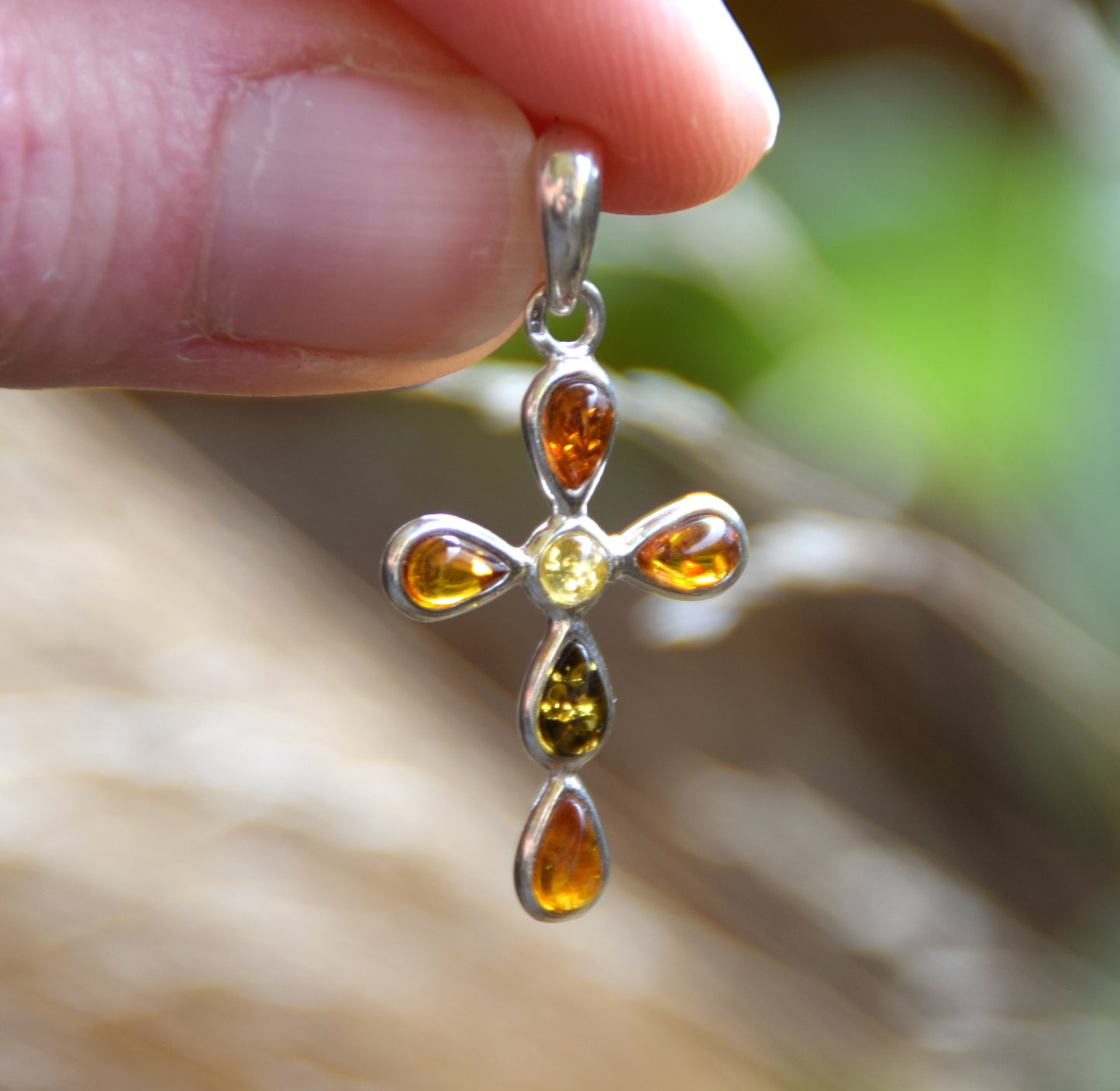 Delicate cross-shaped pendant made of natural amber in various shades and 925 sterling silver, MJ Baltica, BW257