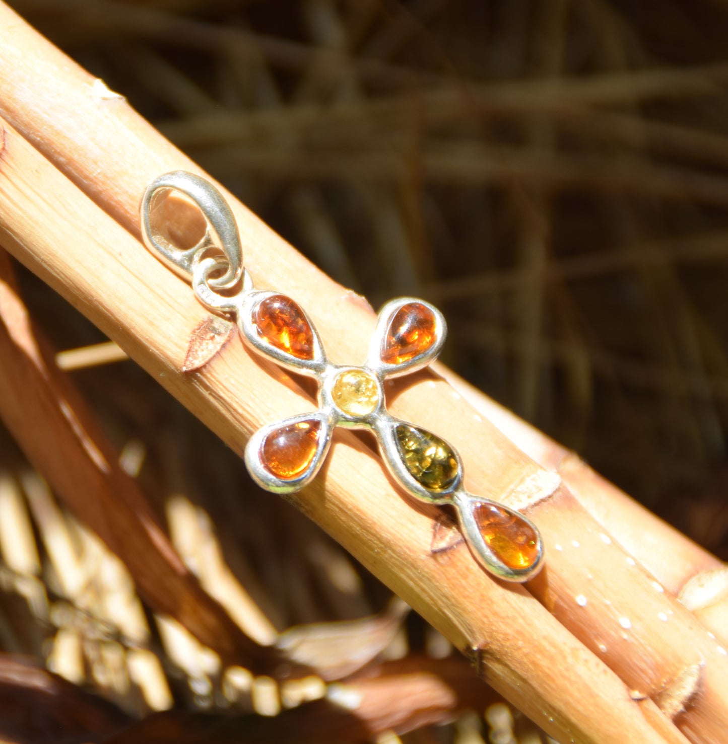 Delicate cross-shaped pendant made of natural amber in various shades and 925 sterling silver, MJ Baltica, BW257