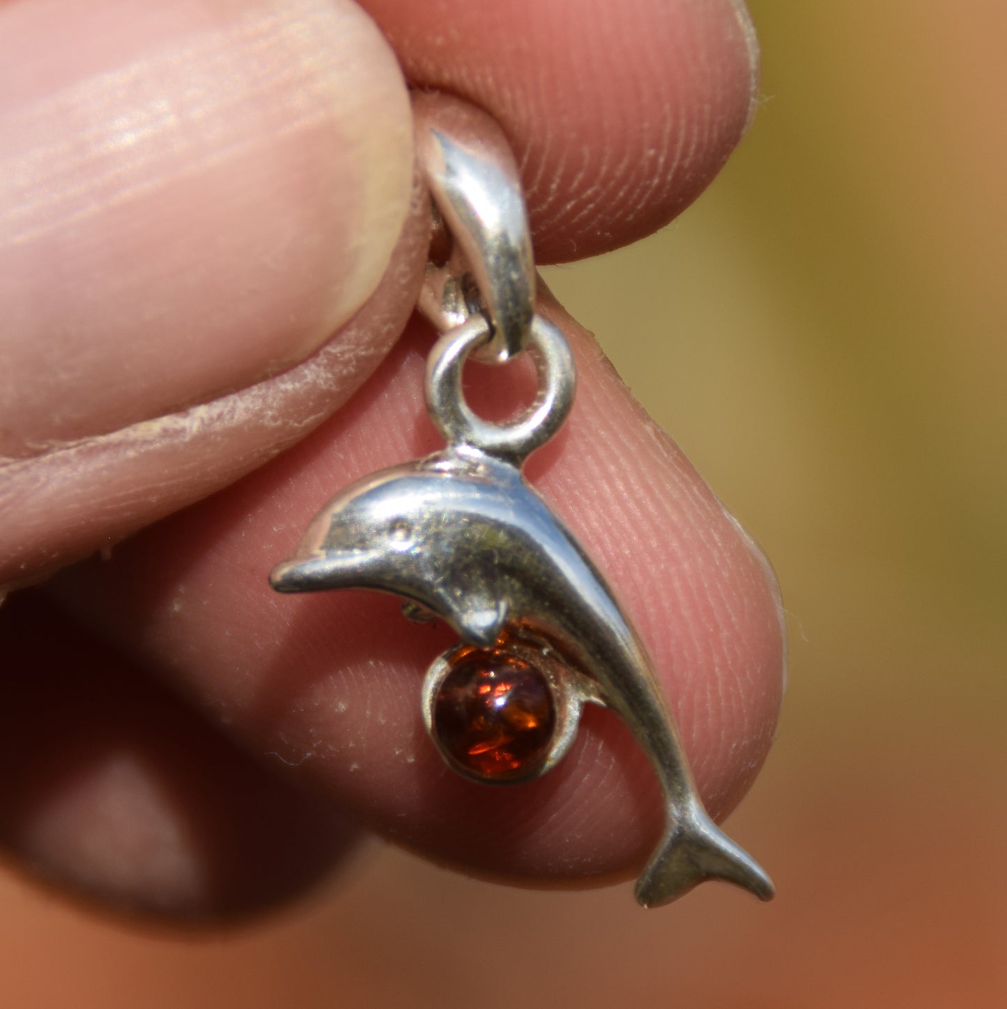 Delicate pendant with a joyful dolphin in cognac-colored natural Amber and 925 Silver, MJ Baltica, BW315